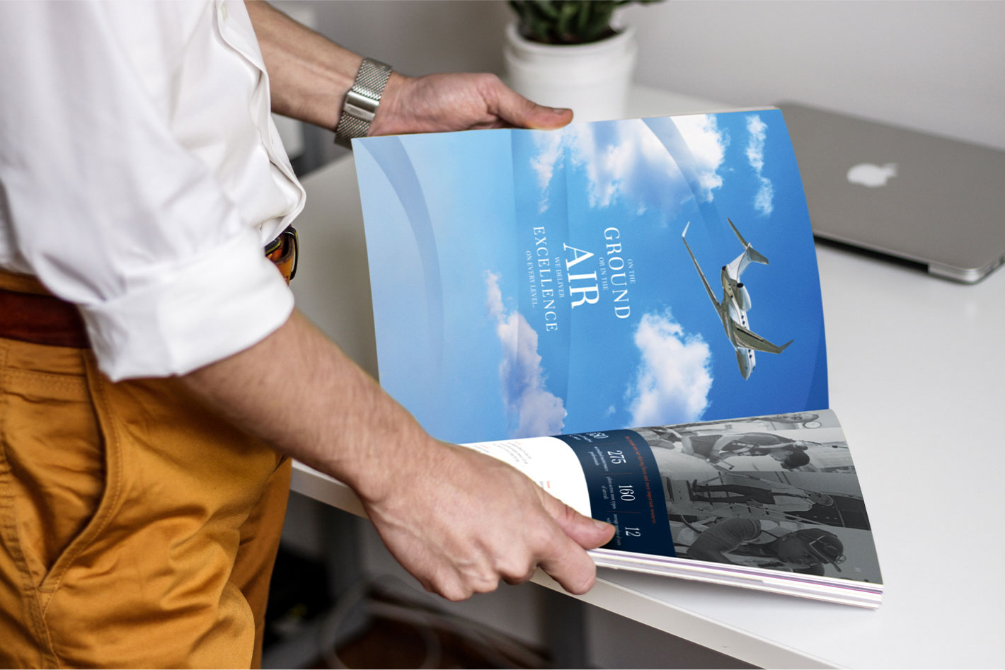 Male customer standing and reading an open Skyservice corporate brochure