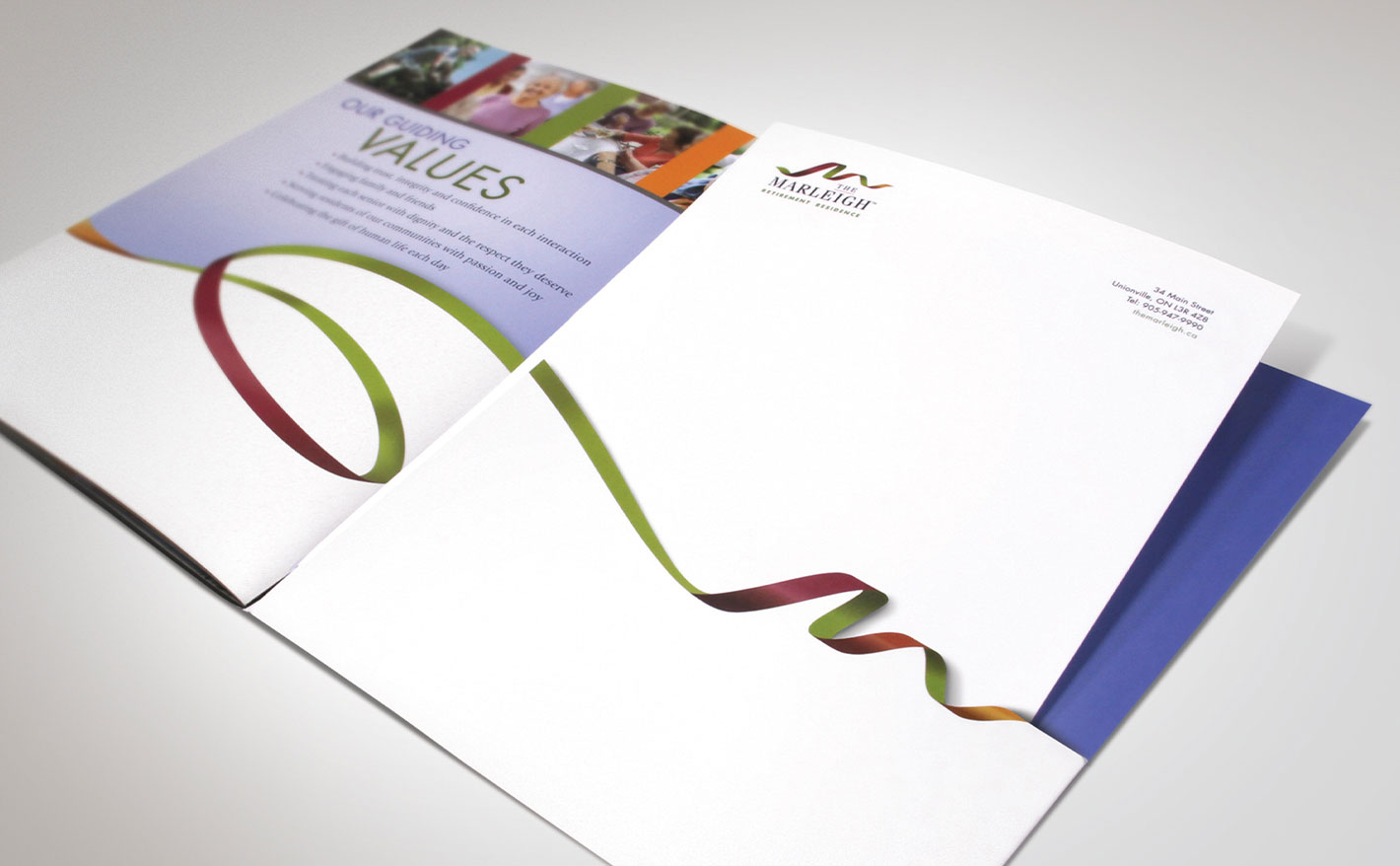 The Marleigh pocket folder and letterhead laid out on a table